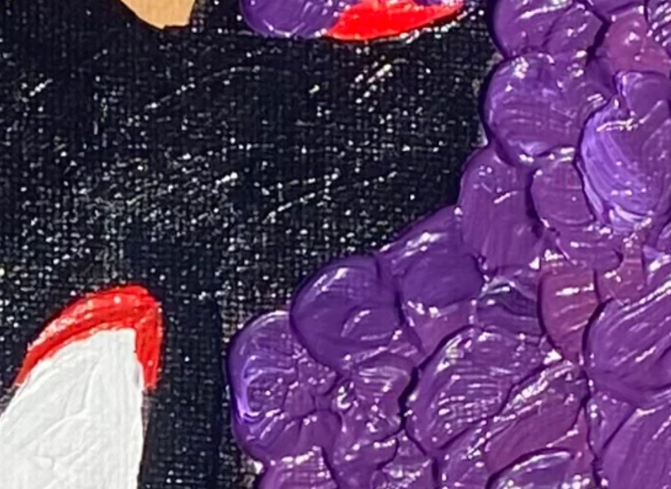 Close-up of a textured purple surface with colorful abstract shapes on a purple background