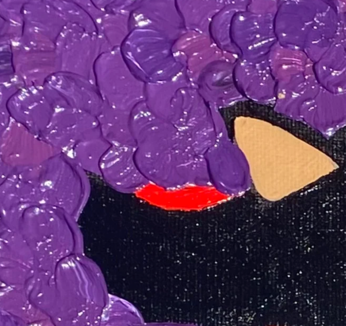Close-up of a textured purple surface with a black and red area