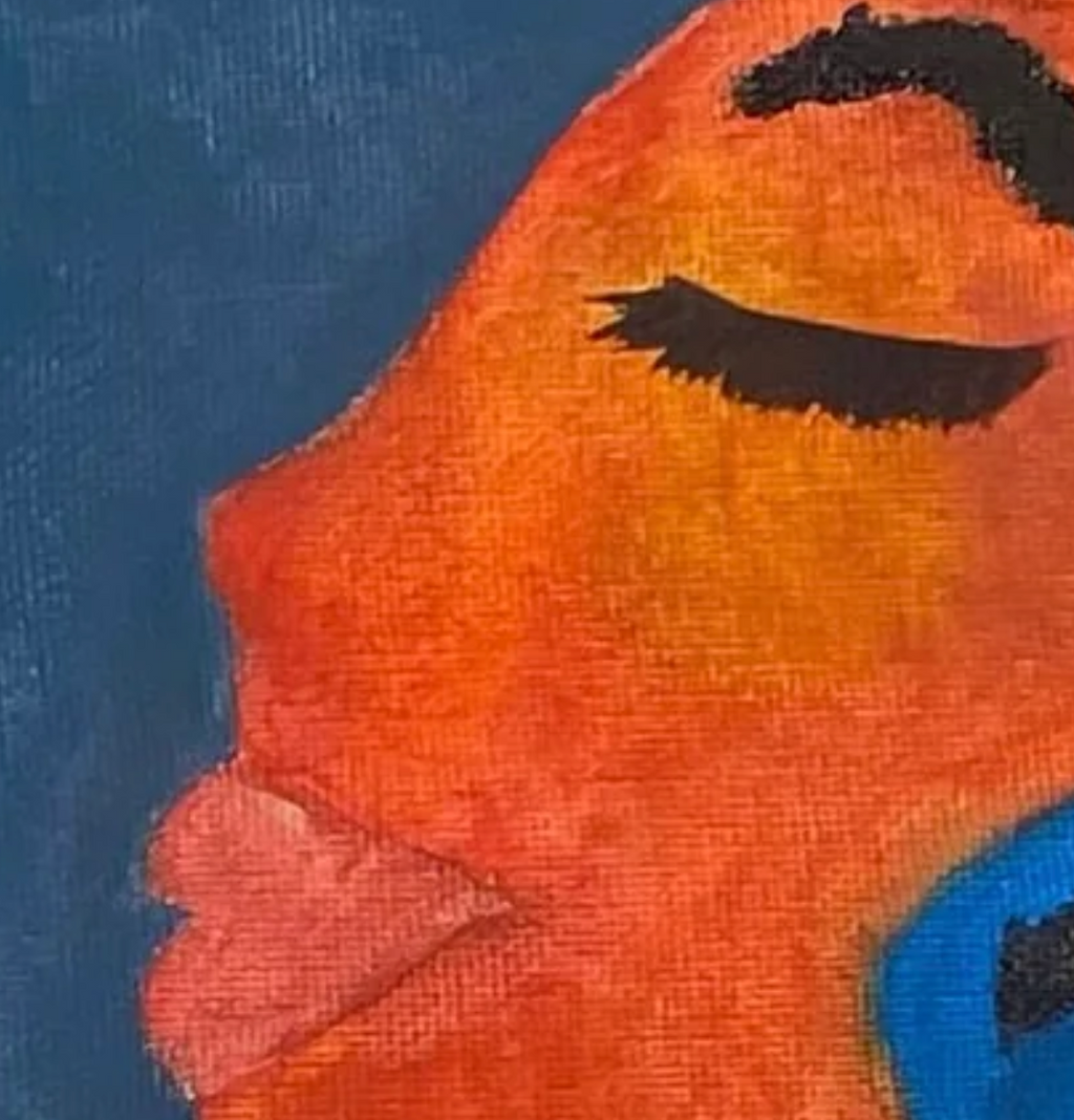 Close-up of a character with an orange face and blue clothing against a dark background