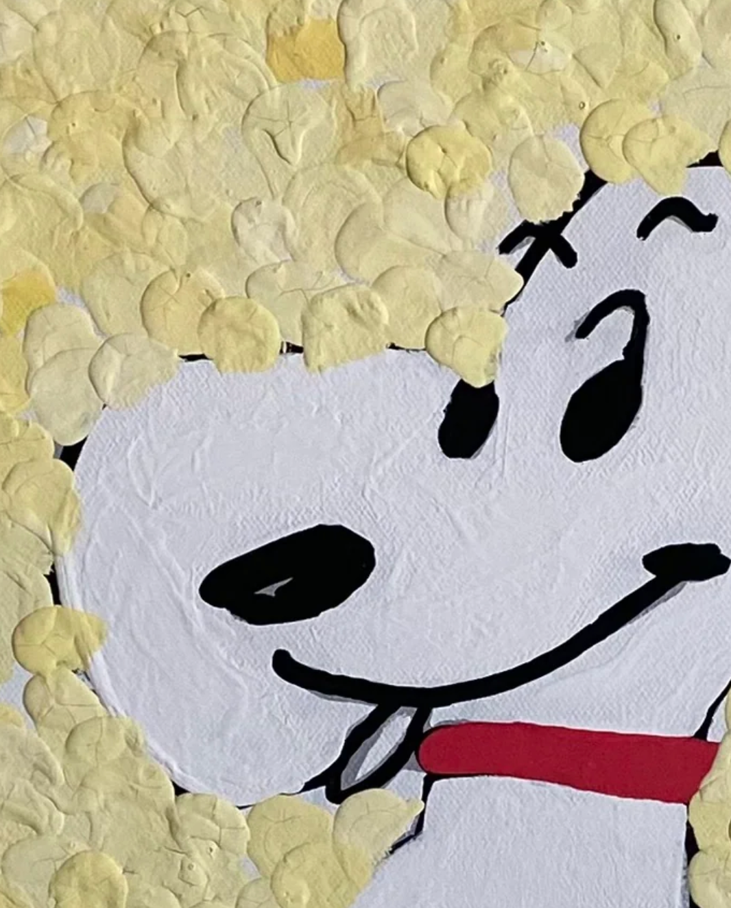 Cartoon character with a white face, black eyes, and red bow tie surrounded by yellow background