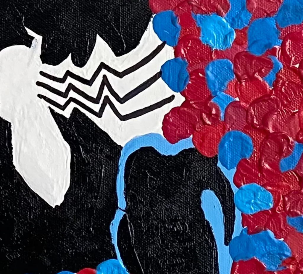 Close-up of a character with a black, white, and red design on a textured background.